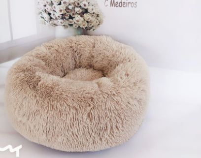 cat sleeping comfortably in fluffy pet nest