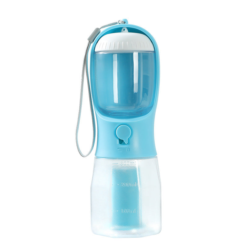 dog using travel water bottle during outdoor walk